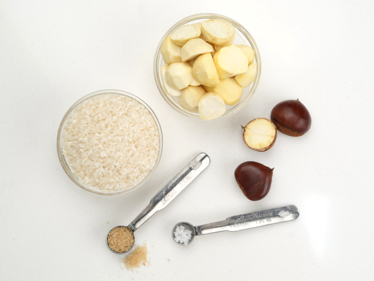 유기농쌀 국산밤 밤설기에 들어가는 재료 평면 연출로 쌀과 깐 밤 유기농 설탕 천일염이 계량스푼과 함께 가지런히 배치